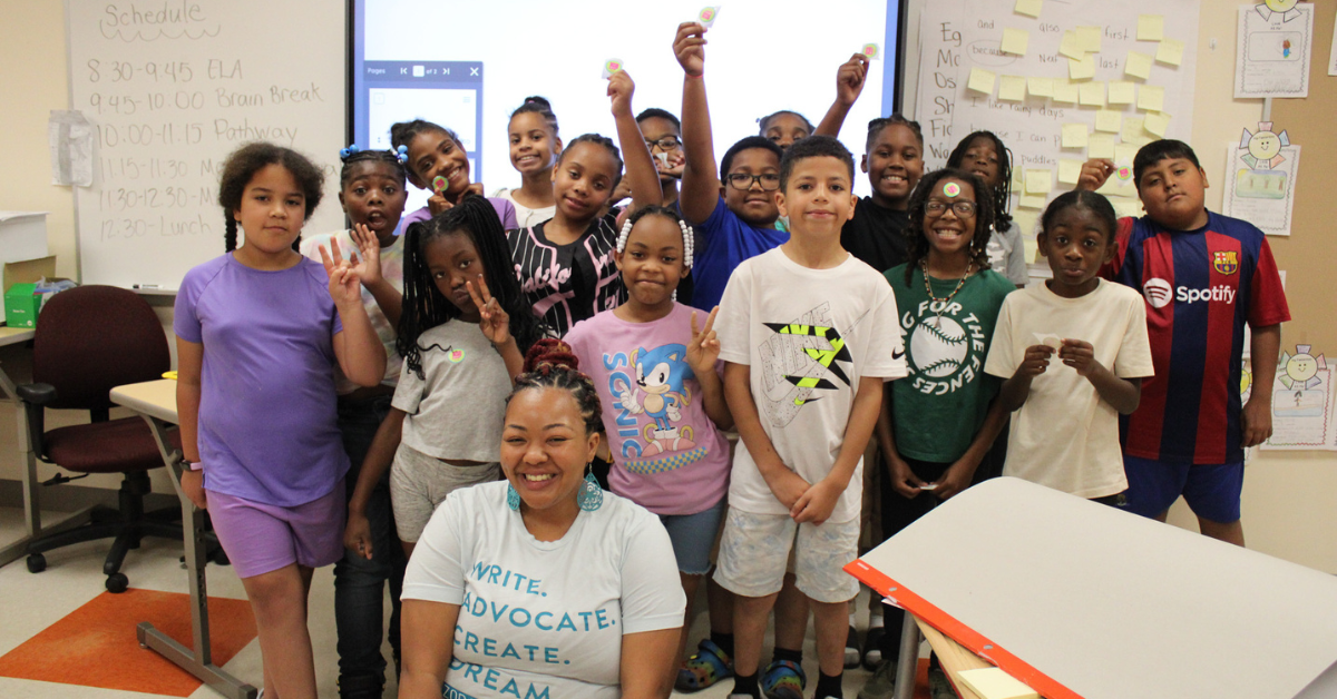 group of students smiling with a woman